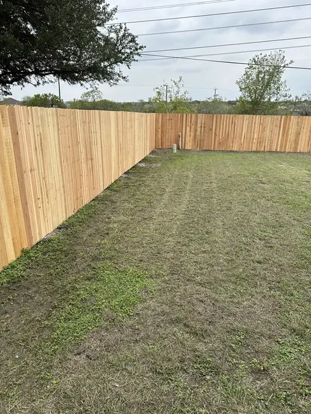 Wooden privacy fence along a backyard property line in Cibolo, TX