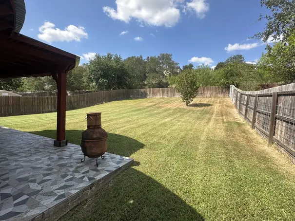 Backyard lawn mowing and property maintenance service in Cibolo, TX