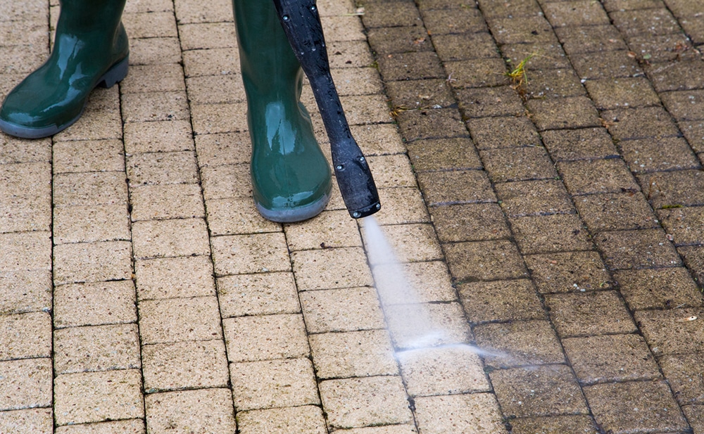 Pressure washing concrete paver walkway at a home in Cibolo, TX